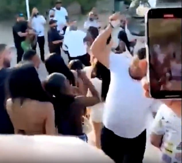 Several spectators were filming the incident on their phones when another security guard burst into the crowd to confiscate their devices.