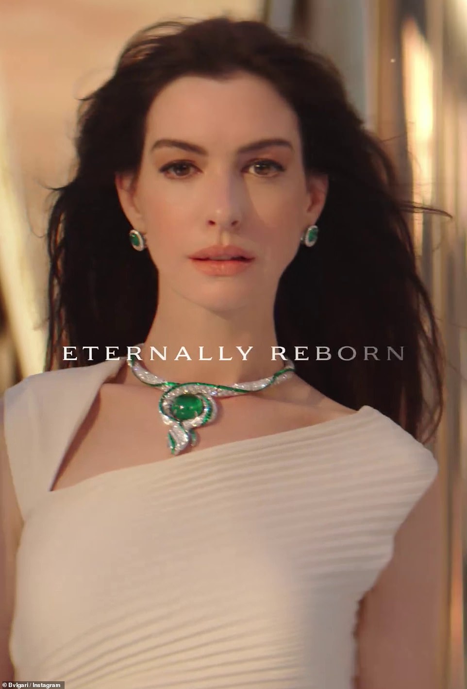 Anne Hathaway also looked amazing in a white dress and emerald necklace in the commercial.