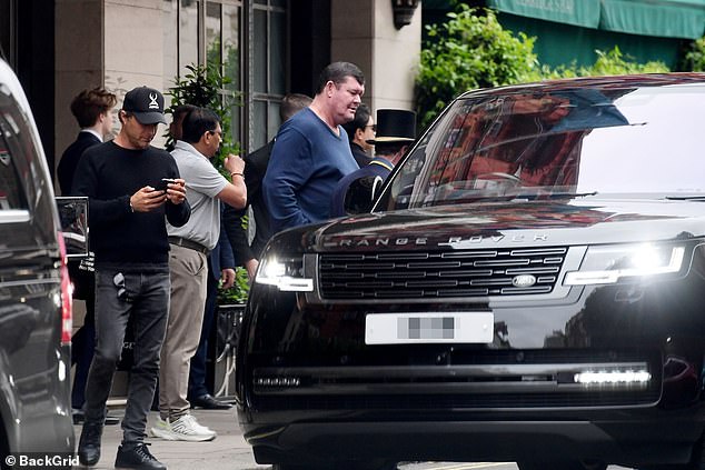 The Australian billionaire, 56, was caught leaving Claridge's hotel, where he is staying with the model.