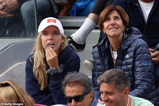 De Minaur's girlfriend, Katie Boulter (pictured left), cheers him on during the victory.