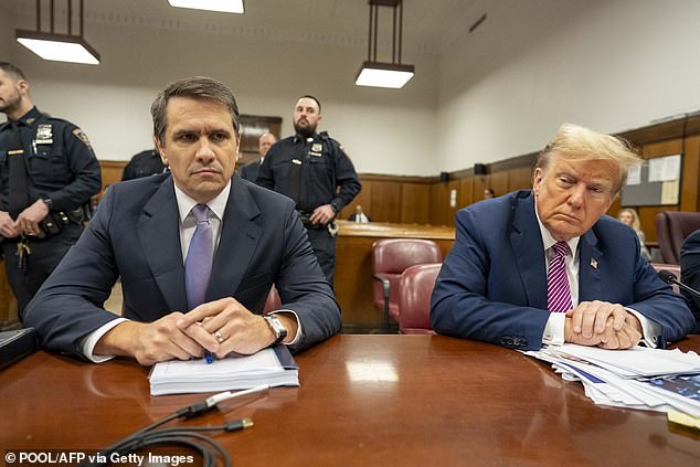 Attorney Todd Blanche sits with former US President Donald Trump as they attend Trump's trial for allegedly covering up hush money payments related to extramarital affairs.