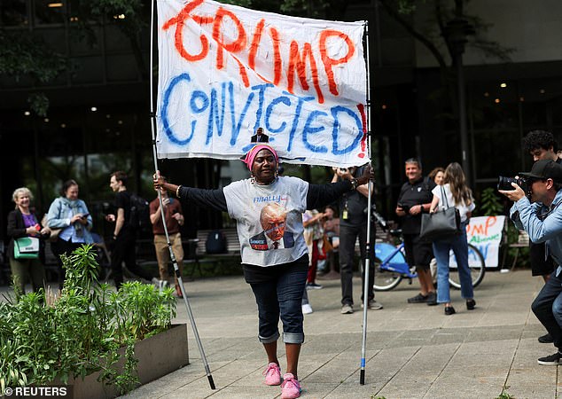 A protester holds a sign outside Manhattan Criminal Court after the verdict.