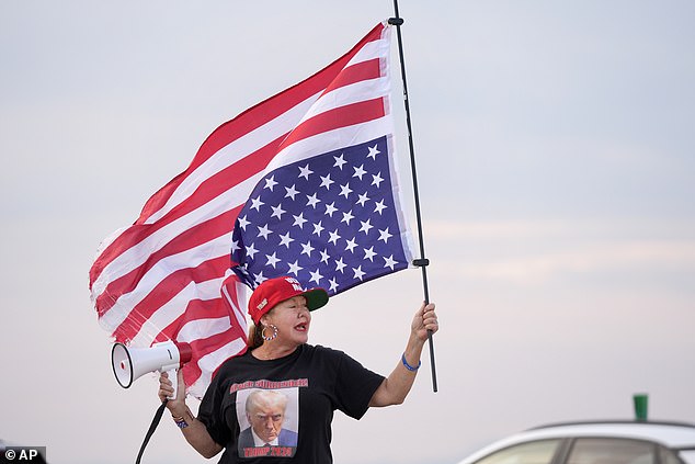 Maria Korynsel, a supporter of former President Donald Trump, demonstrates near Trump's Mar-a-Lago estate