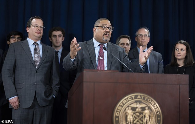 Manhattan District Attorney Alvin Bragg (center) speaks with prosecutor Joshua Steinglass (left), next to him, at a triumphant press conference following the verdict.