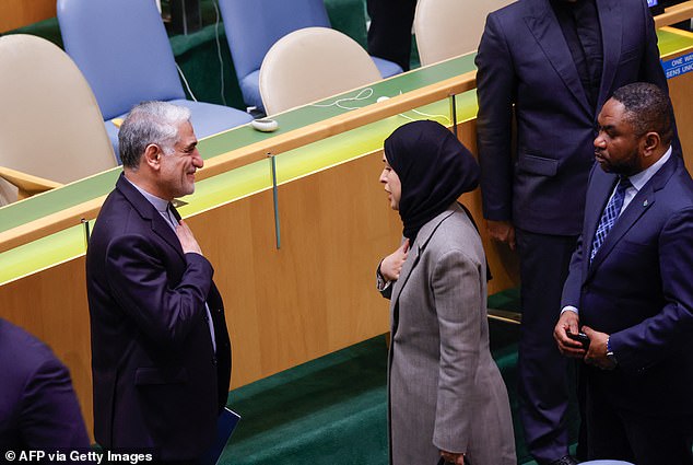 Iranian Ambassador to the United Nations Saeed Iravani (L) receives condolences during a United Nations (UN) General Assembly tribute to the late Iranian leader.