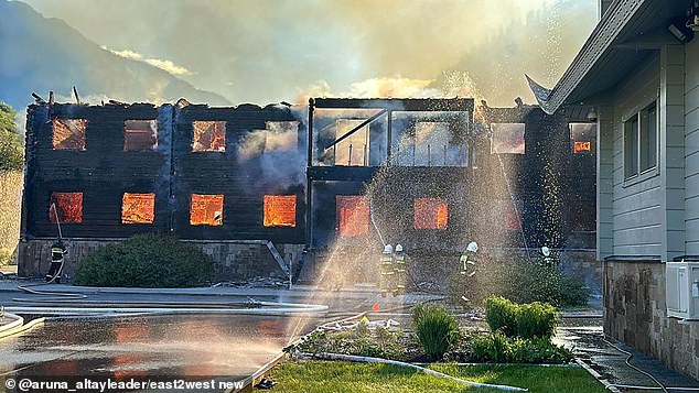 Firefighters are seen working to extinguish the fire in the Altai Republic.