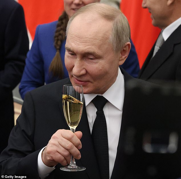 Russian President Vladimir Putin (center) toasts during an awards ceremony at the Kremlin on May 30, 2024, in Moscow.