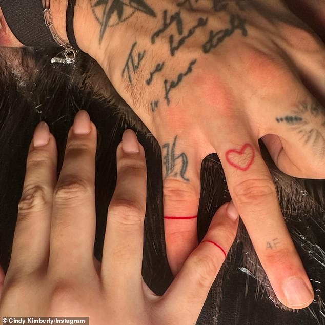 Dele and Cindy began dating in 2022 and debuted matching ring tattoos (pictured) in April, showing the world that their relationship is here to stay.