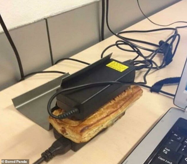 An office worker bizarrely demonstrated how to double laptop chargers as food warmers.