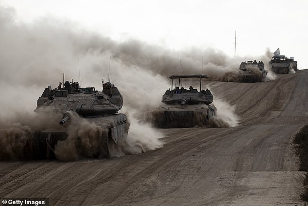 Israeli tanks advance along the border with the Gaza Strip on May 29