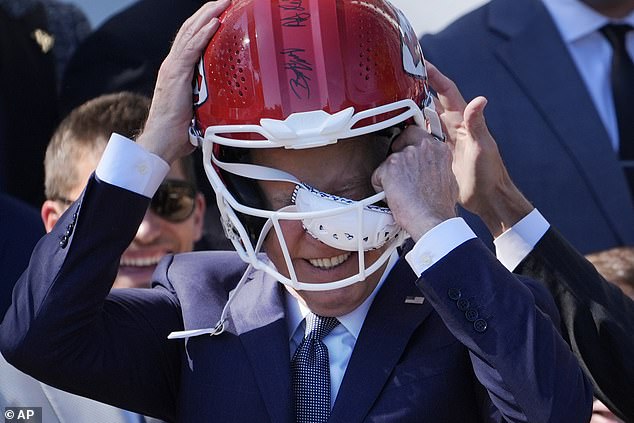 President Joe Biden stuck his head into a Kansas City Chiefs helmet during the team's Super Bowl event on the south field.