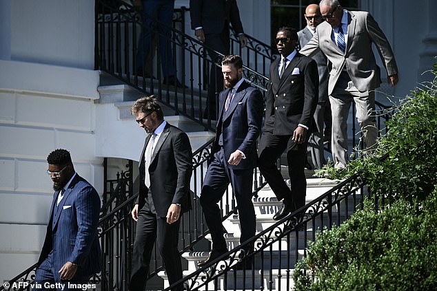 Members of the Kansas City Chiefs, including kicker Harrison Butker (third from left), arrive for a south field ceremony on Friday.