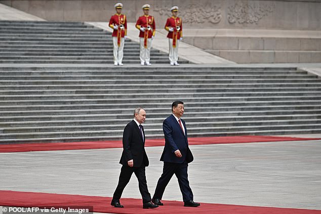 Russia's President Vladimir Putin and China's President Xi Jinping attend an official welcoming ceremony in front of the Great Hall of the People in Tiananmen Square in Beijing.