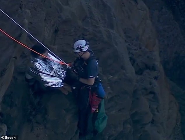 Shortly after lunchtime on Sunday, a team of NSW Ambulance paramedics abseiled down the steep cliff face to help move Mr Hart to a location where he could be safely transported to a helicopter .