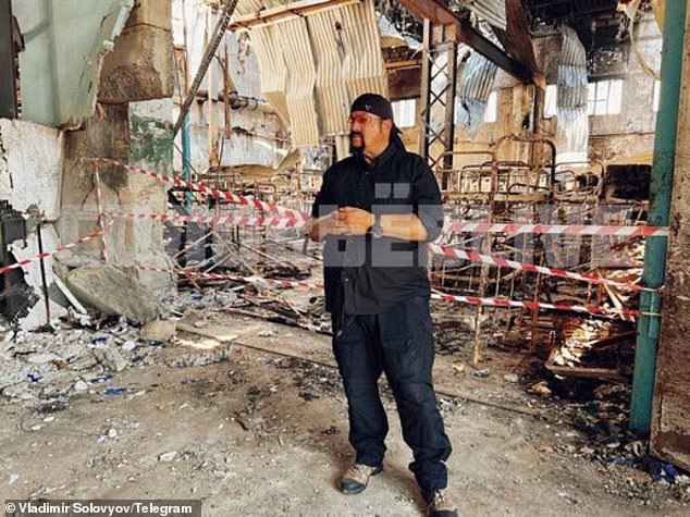 American actor Steven Seagal is seen standing inside the bombed compound where at least 50 Ukrainian prisoners died on July 29.