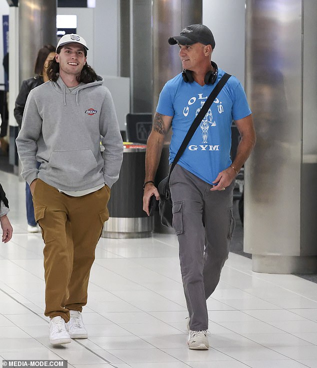 Shannon showed off his muscle gear in a tight blue logo t-shirt and a pair of gray cargo pants.