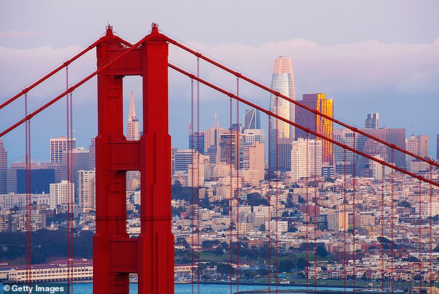 The Golden Gate Bridge tower with the San Francisco cityscape in the background