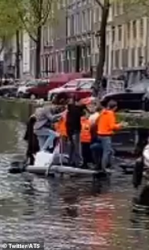 This is the moment a party in Amsterdam went south when a boat of revelers slowly sank underwater as they celebrated King's Day at the weekend.