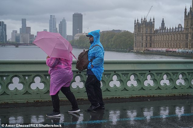 In news that will not surprise most Britons, the Met Office confirmed that April was the sixth wettest since records dating back to 1836. Pictured: Pedestrians on Westminster Bridge on April 19.