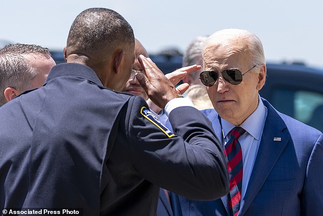 President Joe Biden greets Charlotte-Mecklenburg Police Department Chief Johnny Jennings as he arrives on Air Force One at Charlotte Douglas International Airport.  Biden met with families of law enforcement officers shot and killed on the job
