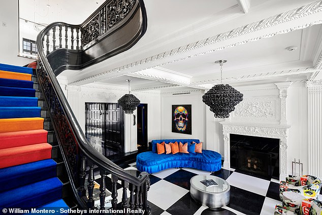 Red, orange, blue and purple steps lead to the second floor of the house.