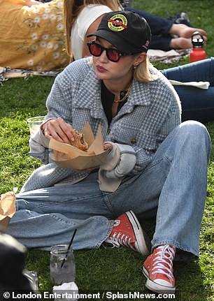 While Bradley showed off his cooking skills, Gigi was seen sitting on the grass.