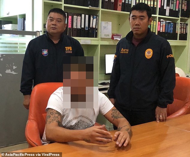 The Welshman appears detained with the Thai police after allegedly hitting the Russian.