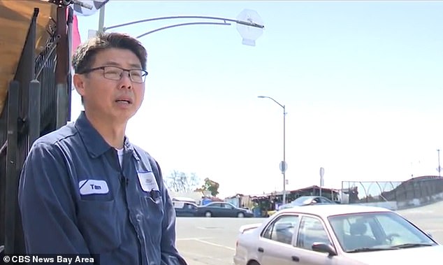 The owner of a vehicle repair shop on the corner of the intersection, Tam Le (pictured), said the city is signaling that it is 