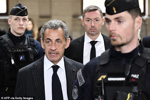 Former French President Nicolas Sarkozy (center left) arrives at the Paris court to receive the verdict in his appeal trial in the so-called Bygmalion case, on February 14, 2024.