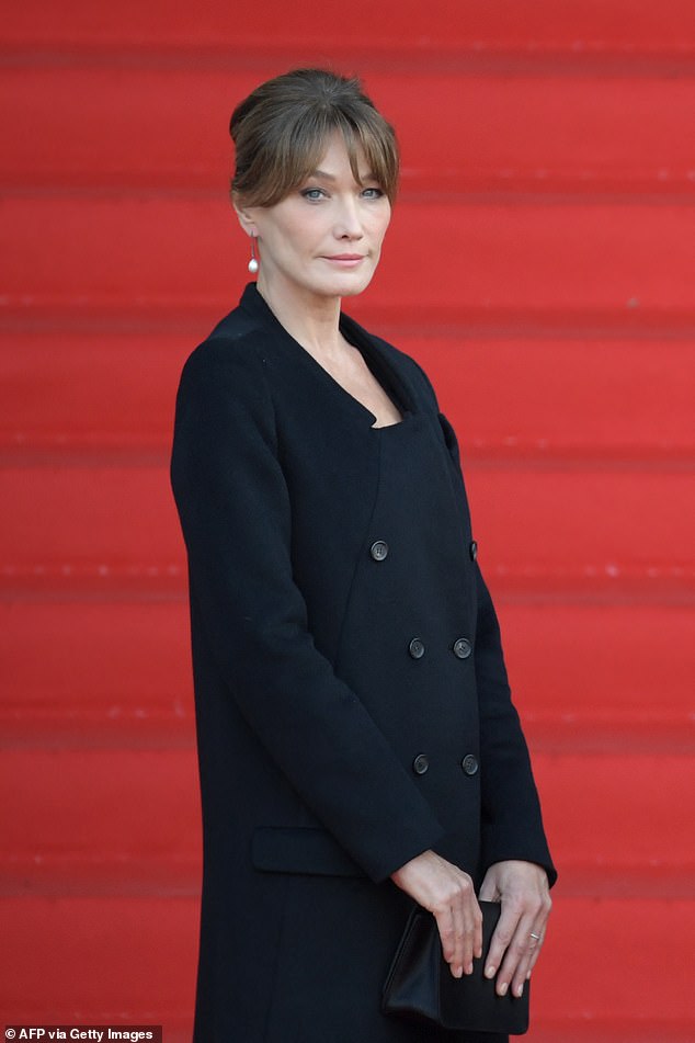 Former French first lady and supermodel Carla Bruni (pictured) was questioned by police today as a suspect in a wide-ranging corruption case.