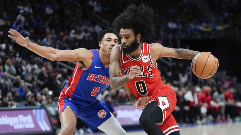Chicago Bulls guard Coby White (0) tackles Detroit Pistons guard Jared Rhoden (8) in the first half of an NBA basketball game in Detroit, Thursday, April 11, 2024. (AP Photo/Paul Sancya)