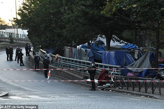 French mobile riot gendarmes stand next to the Forceval garden square during the dismantling of a camp for crack addicts, northeast of Paris in 2022.
