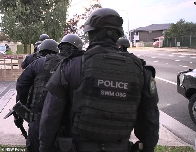 New South Wales Police (pictured, heavily armed officers) have established a strike force to investigate the church riot.