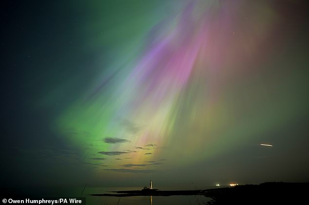 TINO AND WEAR: The Northern Lights, also known as the Northern Lights, shine on the horizon at St Mary's Lighthouse in Whitley Bay on the north east coast