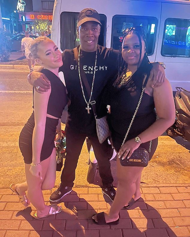 Marlon McCormack, 51, suffered a brain hemorrhage and is currently in an induced coma.  He is pictured the night before he became ill with his daughter Renelle (right) and his 16-year-old sister (left).