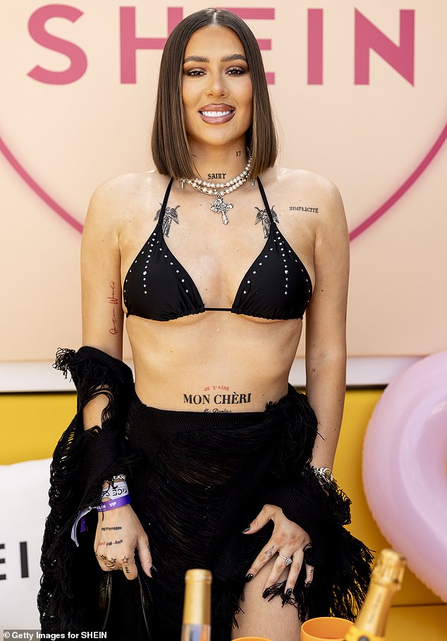 House Of Sims star Demi showed off her many tattoos in a sexy black bikini and ripped jeans combo.