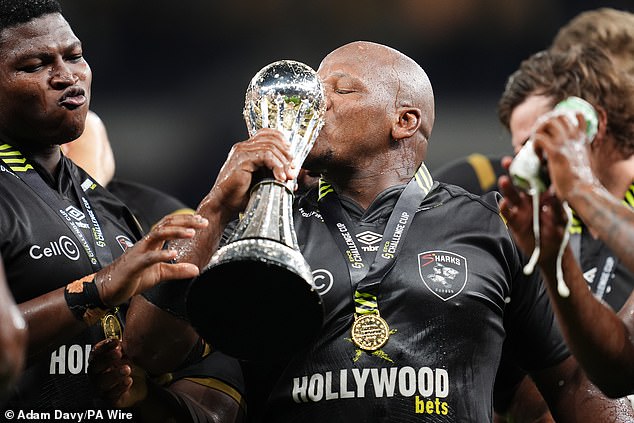 Part of Shark's 'Bomb Squad', Bongi Mbonambi, kisses the Challenge Cup trophy after victory