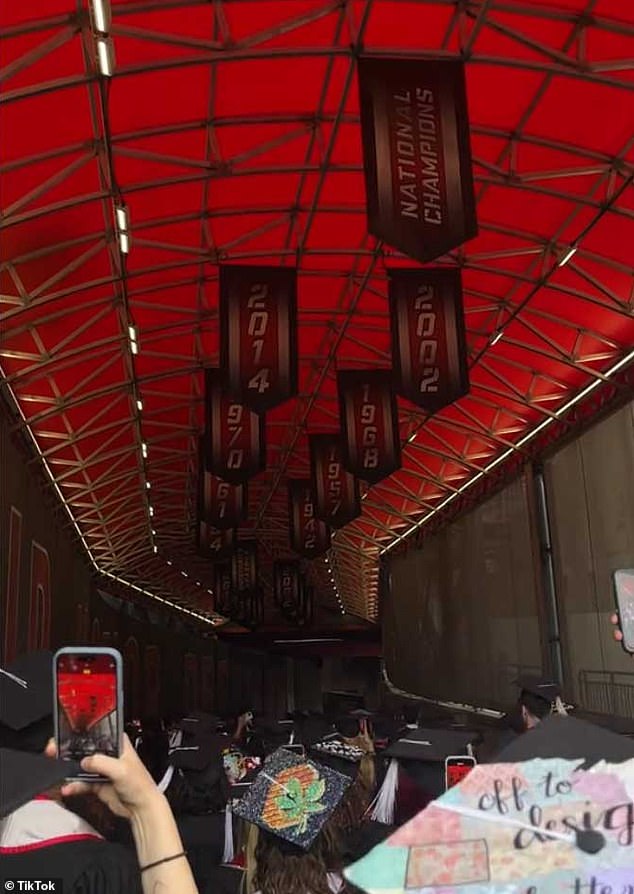 The person fell from the stands just as the graduates were entering the stadium through one of the tunnels.