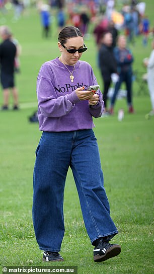 The mother of two elevated her look with several pieces of gold jewelry, including stacked necklaces, numerous rings, and a pair of luxe earrings.