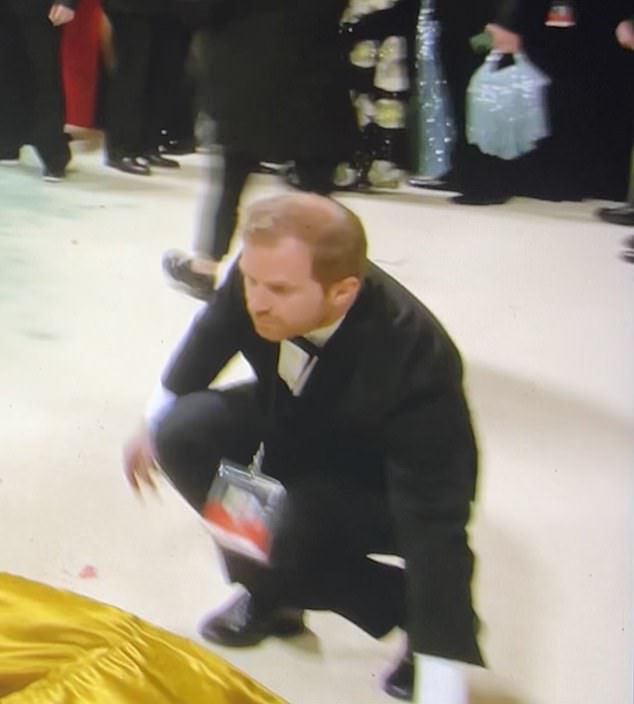 Prince Harry's lookalike was working at the Met Gala last night when social media users were shocked when they thought the royal was lifting up the trains of her dress.