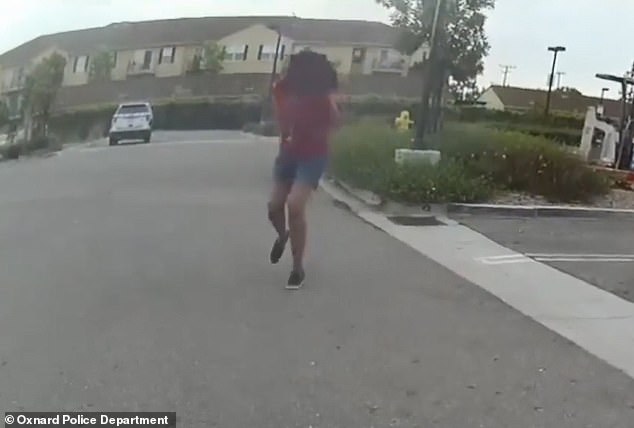 The officer backs away until the girl runs away, prompting him to shoot her three times.