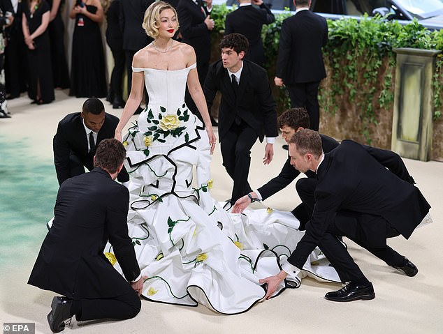 Gigi Hadid (pictured) reportedly needed the help of about five staff members just to get up the stairs in her luxurious dress.