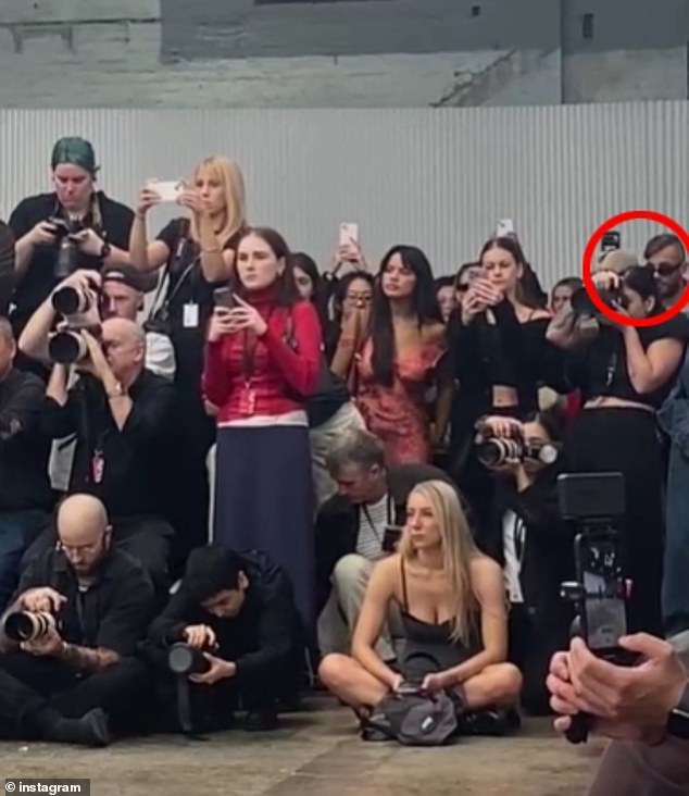 In a photo on social media, Azzopardi can be seen squeezed into the back corner of the busy media pit as they try to peer past photographers to see the runaway spectacle.