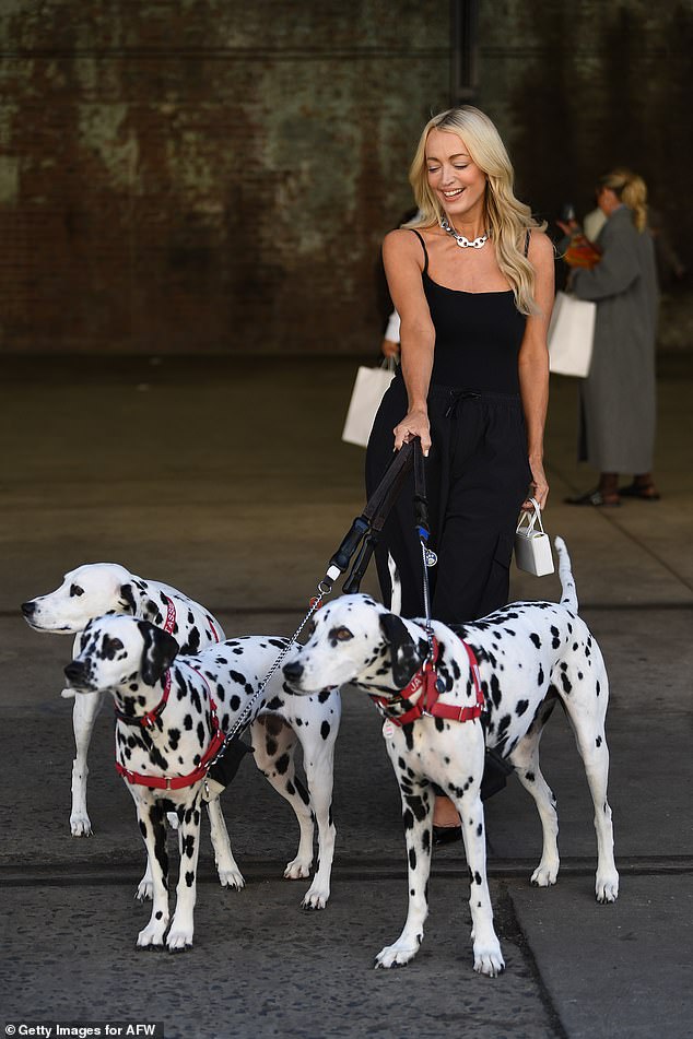 Elsewhere at AFW, Jackie was seen walking with three adorable Dalmatian dogs as she stepped out to support her friend Pip at her fashion show.