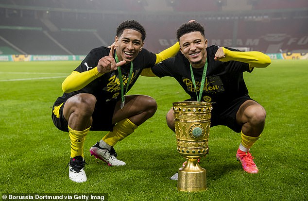 Real Madrid midfielder Jude Bellingham (left) and Manchester United star Jadon Sancho (right) celebrate together in 2021 after helping Borussia Dortmund win the German Cup.
