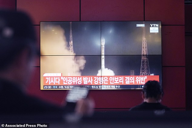 A television screen shows a file image of North Korea's rocket launch during a news program at a bus terminal in Seoul, South Korea, Monday, May 27, 2024.