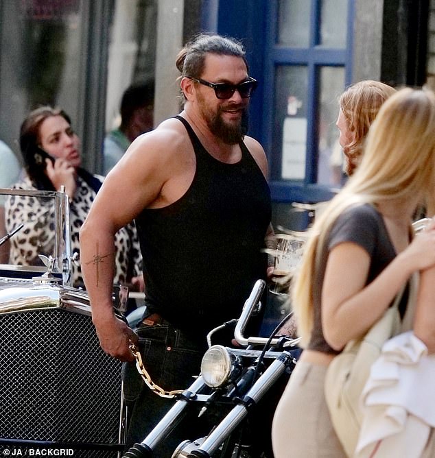 The Hollywood leading man, who showed off his bulging muscles in a tank top and blue jeans, checked out a parked motorcycle after his crew parked outside a local pub.