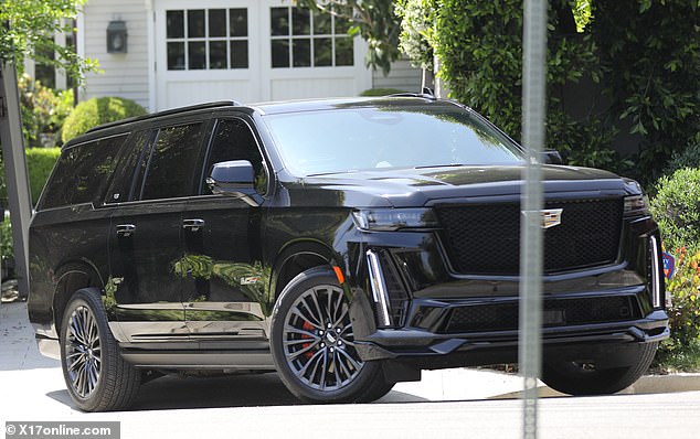 She was immediately seen getting into her Cadillac Escalade and driving away (pictured), but Ben appeared to stay in his $100,000-a-month rental mansion.