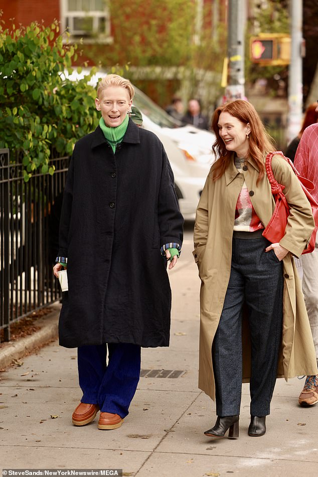 Tilda Swinton (L) and Julianne Moore (R) smiled and laughed on the New York set of their first movie together, The Room Next Door, on Monday.