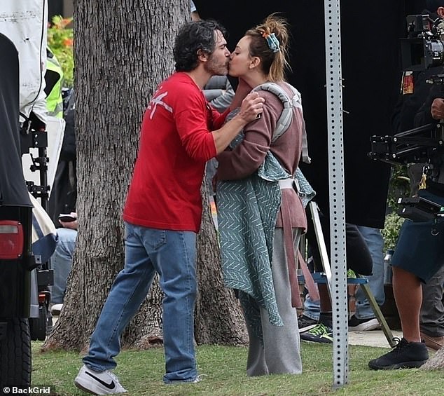 The actors, who play true crime podcasters on the Peacock show, appeared to be in a heated conversation before sharing a kiss for the camera.